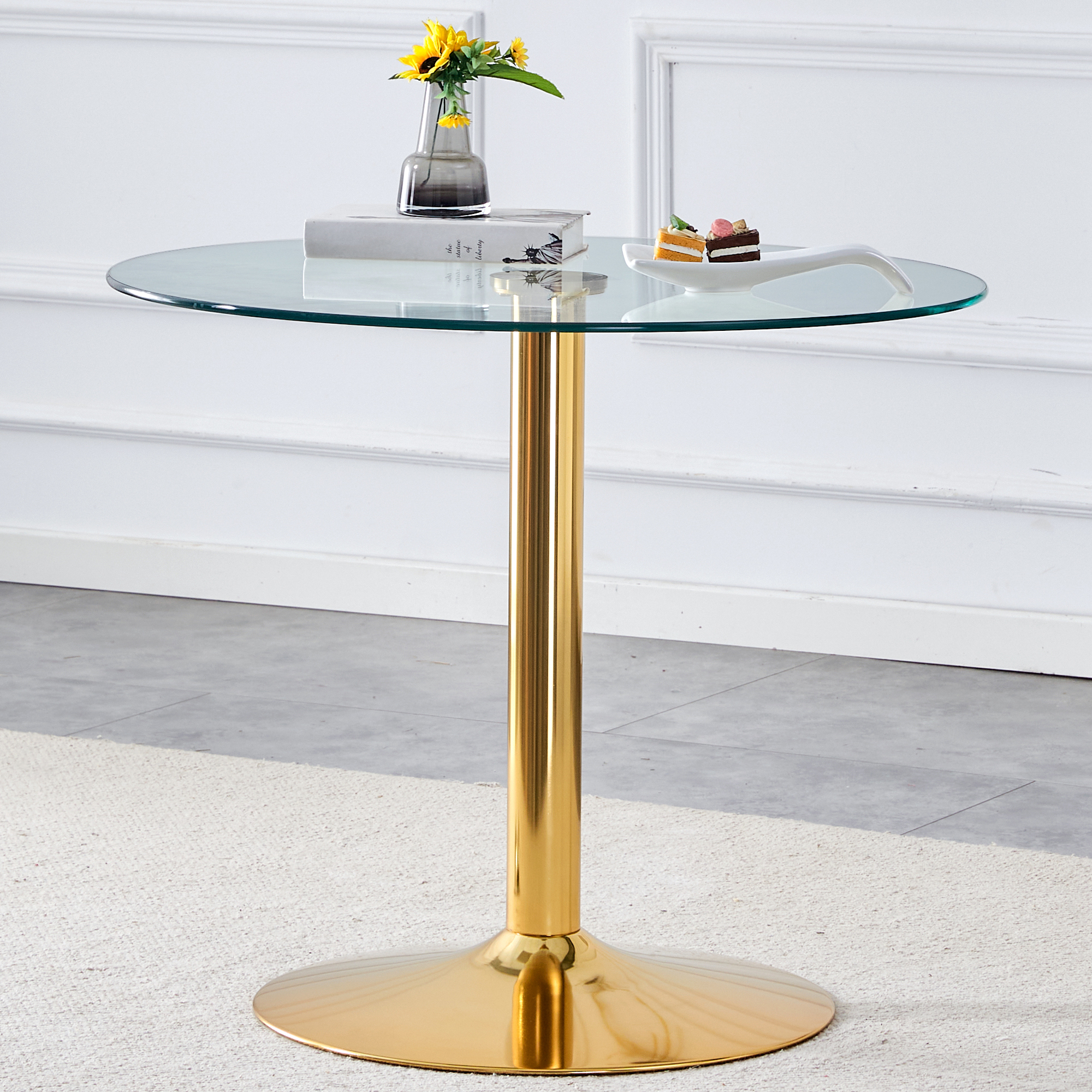 A 35-inch diameter glass top and a modern, minimalist round dining table with gold metal legs. Ideal for dining rooms, living rooms and meeting rooms. Model: DT-1166